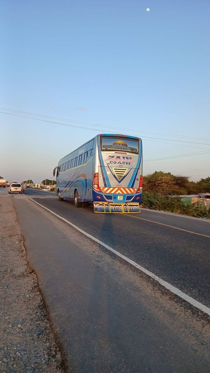 Zain Coach bus on the highway at dusk